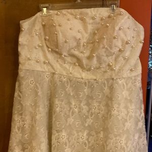It’s a beautiful only worn once knee length strapless dress and hand sewn pearls